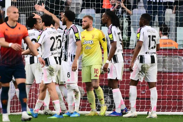 Juventus players celebrate after Juventus' Italian goalkeeper #16 Michele Di Gregorio makes a save on a penalty kick during the Italian Serie A football match between Juventus and Genoa at the Allianz stadium in Turin, on April 6, 2026. (Photo by Marco BERTORELLO / AFP)