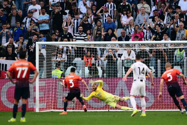Juventus' Italian goalkeeper #16 Michele Di Gregorio saves a penalty kick by Genoa's Spanish defender #03 Aaron Martin during the Italian Serie A football match between Juventus and Genoa at the Allianz stadium in Turin, on April 6, 2026. (Photo by Marco BERTORELLO / AFP)