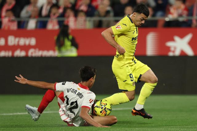 Girona's Brazilian defender #12 Vitor Reis and Villarreal's French forward #09 Georges Mikautadze fight for the ball during the Spanish league football match between Girona FC and Villarreal CF at Montilivi Stadium in Girona on April 6, 2026. (Photo by Lluis GENE / AFP)