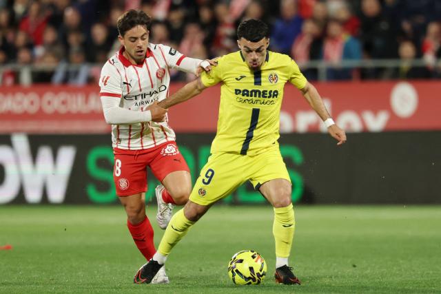Girona's Spanish midfielder #08 Fran Beltran and Villarreal's French forward #09 Georges Mikautadze fight for the ball during the Spanish league football match between Girona FC and Villarreal CF at Montilivi Stadium in Girona on April 6, 2026. (Photo by Lluis GENE / AFP)