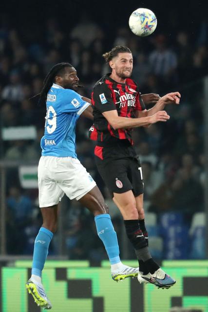 AC Milan's French midfielder  #12 Adrien Rabiot (R) and Napoli's Cameroonian midfielder #99 Andre-Frank Anguissa (L) fight for the ball in the air during the Italian Serie A football match between SSC Napoli and AC Milan at the Diego Armando Maradona Stadium in Naples on April 6, 2026. (Photo by CARLO HERMANN / AFP)