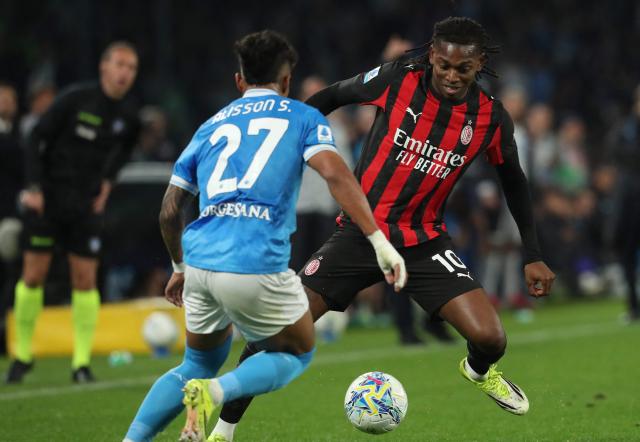 Milan's Portuguese forward #10 Rafael Leao (R) runs with the ball towards Napoli's Brazilian midfielder #27 Alisson Santos (L) during the Italian Serie A football match between SSC Napoli and AC Milan at the Diego Armando Maradona Stadium in Naples on April 6, 2026. (Photo by CARLO HERMANN / AFP)