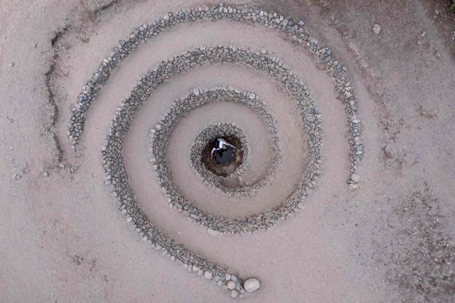 (FILES) A woman stands inside of one of the Cantalloq aqueducts, built by people belonging to the Nazca culture, around 1600 years ago in Nazca, southern Peru on May 17, 2023. With a record 35 candidates running in the upcoming presidential election on April 12, 2026, Peru—rich in mineral resources, renowned gastronomy, and invaluable archaeological heritage—has also long been affected by internal conflict involving the Shining Path and the Tupac Amaru Revolutionary Movement. Since 2016, the country has faced chronic political instability, marked by a succession of eight different heads of state. (Photo by Ernesto BENAVIDES / AFP)