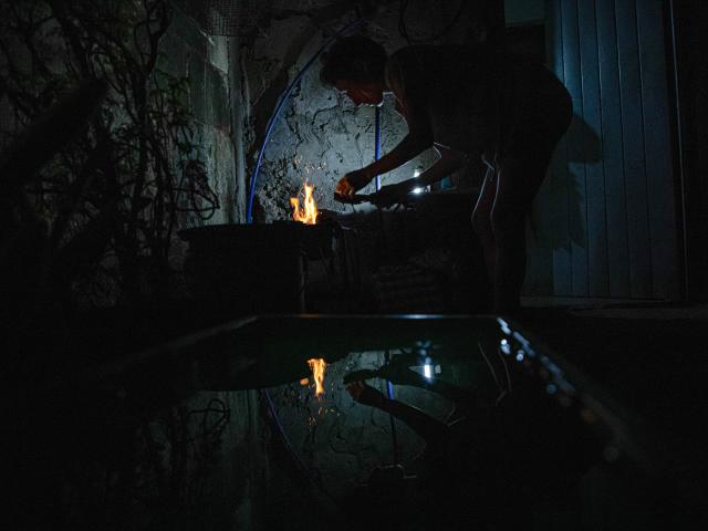 A woman prepares a wood fire to cook food during a blackout in Matanzas, Cuba, on April 6, 2026. Matanzas is one of the Cuban cities most affected by electricity shortages, at times going more than 24 hours without power, despite being home to the Antonio Guiteras Thermoelectric Plant, one of the country’s most important. (Photo by AFP)