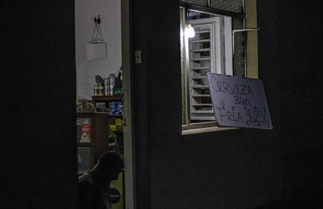 The owner of a small grocery store selling cold beer sits in the doorway of his business during a blackout in Matanzas, Cuba, on April 6, 2026. Matanzas is one of the Cuban cities most affected by electricity shortages, at times going more than 24 hours without power, despite being home to the Antonio Guiteras Thermoelectric Plant, one of the country’s most important. (Photo by AFP)
