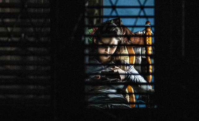 A young woman looks at her phone during a blackout in Matanzas, Cuba, on April 6, 2026. Matanzas is one of the Cuban cities most affected by electricity shortages, at times going more than 24 hours without power, despite being home to the Antonio Guiteras Thermoelectric Plant, one of the country’s most important. (Photo by AFP)