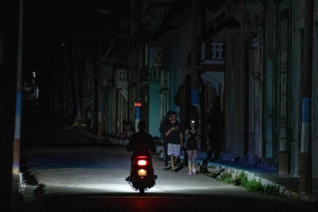 A motorcyclist rides on a dark street during a blackout in Matanzas, Cuba, on April 6, 2026. Matanzas is one of the Cuban cities most affected by electricity shortages, at times going more than 24 hours without power, despite being home to the Antonio Guiteras Thermoelectric Plant, one of the country’s most important. (Photo by AFP)