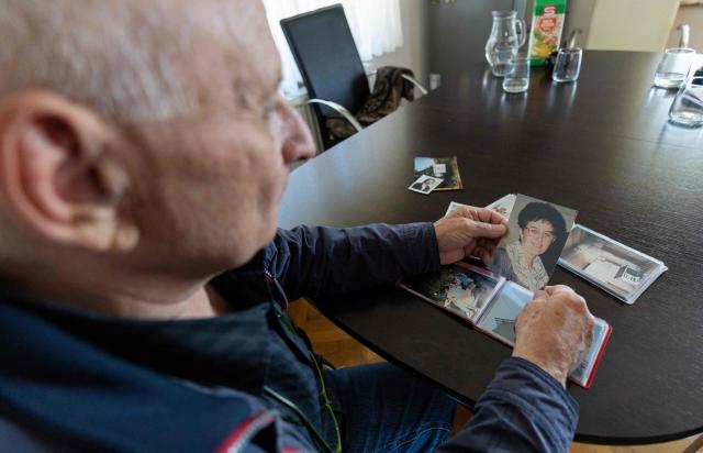 Juraj Pievac (70) looks at a photo of his wife, who died in a mine explosion, in the village of Brodani near Karlovac on March 24, 2026. More than 30 years after the independence war, that left behind around 107,000 landmines and 470,000 unexploded ordnances, Croatia is declared mine-free, a historic milestone for the country. (Photo by MARKO PERKOV / AFP)