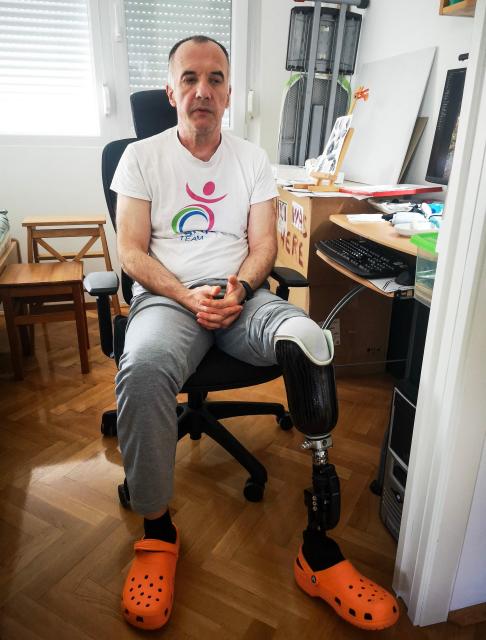 Mirsad Tokic, former deminer who lost his leg in a blast in 2007, while working in a remote village in the Adriatic coast hinterland, poses in his apartment in Zagreb, on March 25, 2026. More than 30 years after the independence war, that left behind around 107,000 landmines and 470,000 unexploded ordnances, Croatia is declared mine-free, a historic milestone for the country. (Photo by Tina SMOLE / AFP)