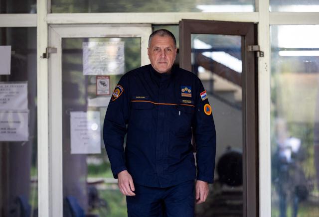 Davor Laura, head of the Croatian Mine Action Centre, leaves his office in Zagreb, on March 25, 2026. More than 30 years after the independence war, that left behind around 107,000 landmines and 470,000 unexploded ordnances, Croatia is declared mine-free, a historic milestone for the country. (Photo by MARKO PERKOV / AFP)