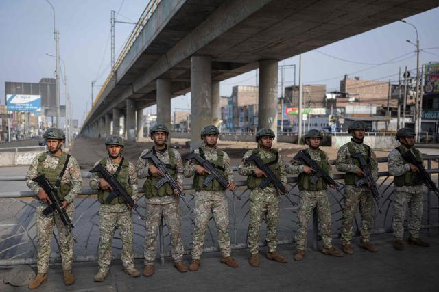 (FILES) Military officers patrol a street after the government declared a state of emergency in Lima on October 22, 2025. After a succession of short-lived presidencies, Peruvians will choose on April 12, 2026, from a record 35 candidates to elect their new leader, who will govern a country gripped by organized crime and chronic political instability. (Photo by ERNESTO BENAVIDES / AFP)