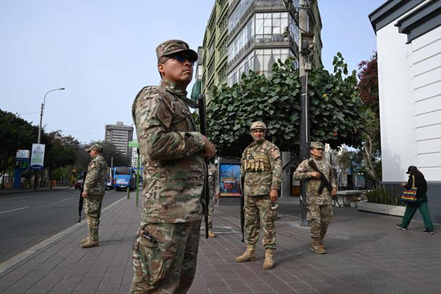 (FILES) Members of the Peruvian Air Force patrol the streets after the government declared a state of emergency in Lima on October 22, 2025. After a succession of short-lived presidencies, Peruvians will choose on April 12, 2026, from a record 35 candidates to elect their new leader, who will govern a country gripped by organized crime and chronic political instability. (Photo by Raul ARBOLEDA / AFP)