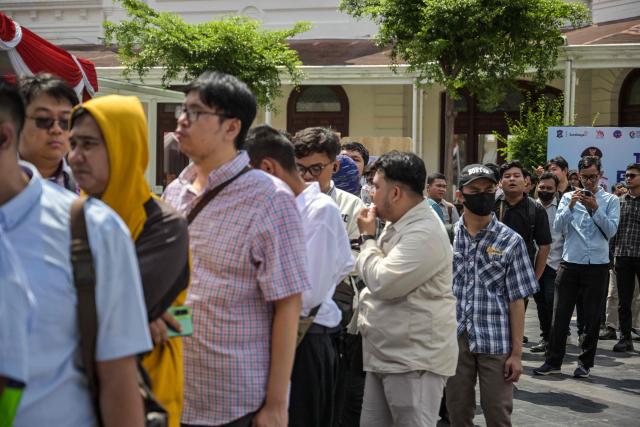 Job seekers queue to register at a jobs fair in Surabaya on April 7, 2026. (Photo by JUNI KRISWANTO / AFP)