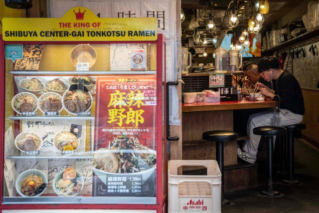 People dine at a ramen restaurant in Tokyo on April 7, 2026. (Photo by Yuichi YAMAZAKI / AFP)