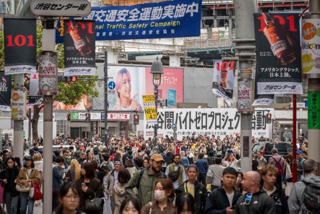 People walk through Shibuya area in Tokyo on April 7, 2026. (Photo by Yuichi YAMAZAKI / AFP)