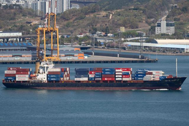 This general view shows a cargo ship carrying containers at Gwangyang Port in Gwangyang on April 7, 2026. (Photo by Shin Yong-ju / AFP)