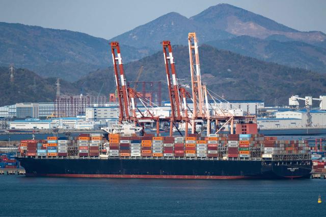 This general view shows a cargo ship carrying containers at Gwangyang Port in Gwangyang on April 7, 2026. (Photo by Shin Yong-ju / AFP)