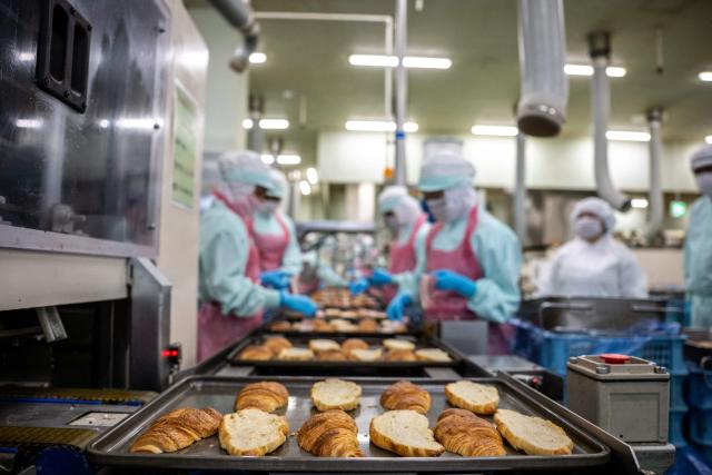 Staff members prepare croissants during a media tour at the factory of Garden Bakery in Akishima city, the western portion of the Tokyo Metropolis on April 7, 2026. (Photo by Philip FONG / AFP)