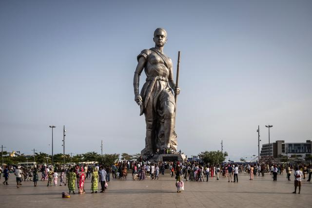 People gather around the Amazon Statue in Cotonou on April 6, 2026. (Photo by OLYMPIA DE MAISMONT / AFP)