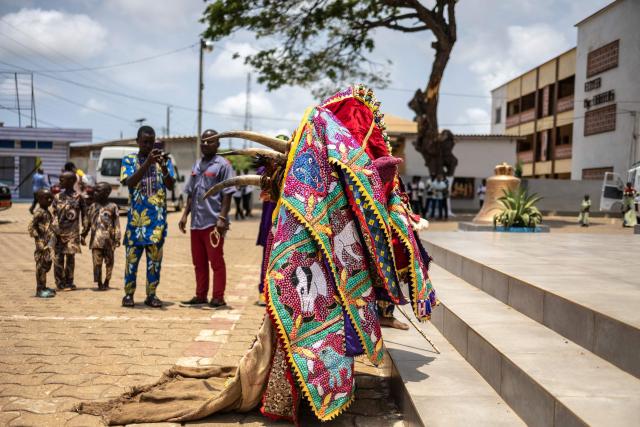 An Egungun, a visible manifestation of the spirits of departed ancestors who periodically revisit the human community for remembrance, celebration, and blessings stands in front of the Basilica of the Immaculate Conception in Ouidah on April 6, 2026. (Photo by OLYMPIA DE MAISMONT / AFP)