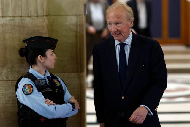 Defendant Brice Hortefeux, former interior minister, leaves the courtroom during a break of the appeal trial of France's former president over charges he sought Libyan financing for his 2007 election, at the Palais de Justice courthouse in Paris on April 7, 2026. The Paris Criminal Court in September 2025 convicted Sarkozy of criminal conspiracy and handed him a 5-year prison sentence over what it said was a scheme to acquire funding from Muammar Gaddafi's Libya for his 2007 presidential run that saw him elected. The right-wing politician -- who has denied any wrongdoing -- entered a Paris jail in October 2025, serving 20 days before he was released under judicial supervision. (Photo by Kenzo TRIBOUILLARD / AFP)