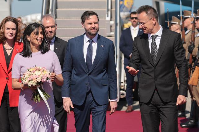 Hungarian Foreign Minister Peter Szijjarto (R) welcomes US Vice President JD Vance (C) and his wife US second lady Usha Vance (2nd L) as they arrive at Budapest Ferenc Liszt International Airport in Budapest, Hungary, April 7, 2026. US Vice President JD Vance arrived in Hungary to deliver US President Donald Trump's support to his ally, nationalist Prime Minister Viktor Orban, ahead of tightly contested parliamentary elections scheduled for April 12, 2026. (Photo by Jonathan Ernst / POOL / AFP)