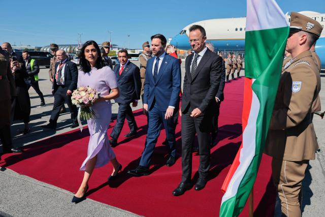 Hungarian Foreign Minister Peter Szijjarto (R) welcomes US Vice President JD Vance (C) and his wife US second lady Usha Vance (L) as they arrive at Budapest Ferenc Liszt International Airport in Budapest, Hungary, April 7, 2026. US Vice President JD Vance arrived in Hungary to deliver US President Donald Trump's support to his ally, nationalist Prime Minister Viktor Orban, ahead of tightly contested parliamentary elections scheduled for April 12, 2026. (Photo by Jonathan Ernst / POOL / AFP)