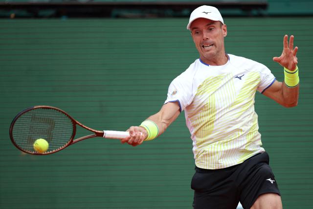 Spain's Roberto Bautista Agut plays a forehand return to Italy's Matteo Berrettini during the Monte Carlo ATP Masters Series Tournament round of 64 tennis match on Court Rainier III at the Monte-Carlo Country Club in Roquebrune-Cap-Martin, south-eastern France on April 7, 2026. (Photo by Valery HACHE / AFP)