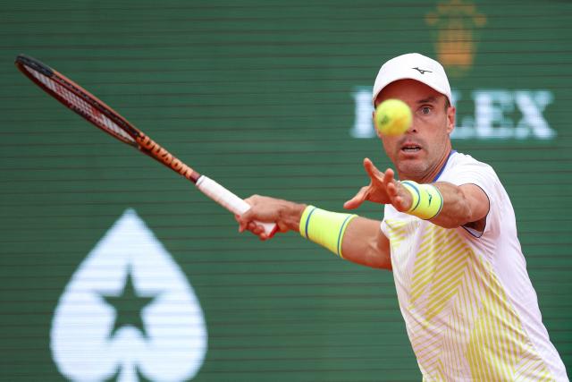 TOPSHOT - Spain's Roberto Bautista Agut eyes the ball as he plays a forehand return to Italy's Matteo Berrettini during the Monte Carlo ATP Masters Series Tournament round of 64 tennis match on Court Rainier III at the Monte-Carlo Country Club in Roquebrune-Cap-Martin, south-eastern France on April 7, 2026. (Photo by Valery HACHE / AFP)