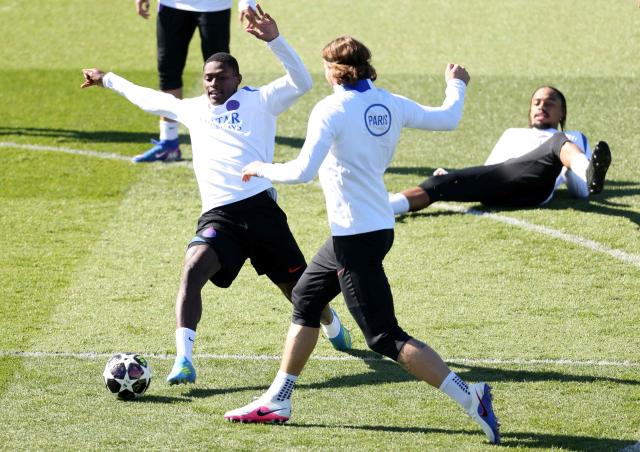 Paris Saint-Germain's Portuguese defender #25 Nuno Mendes (L) fights for the ball with Paris Saint-Germain's Ukrainian defender #06 Illia Zabarnyi during a training session at the Campus Paris Saint-Germain in Poissy, in the western outskirts of Paris, on April 7, 2026, on the eve of the UEFA Champions League last 8 first leg football match between Paris Saint-Germain and Liverpool. (Photo by FRANCK FIFE / AFP)