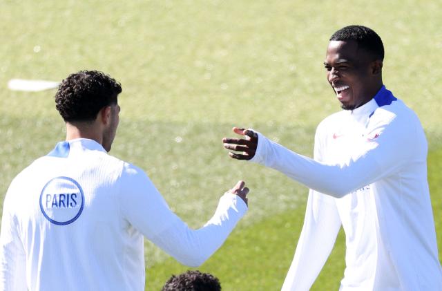 Paris Saint-Germain's French defender #51 William Pacho (R) jokes with Paris Saint-Germain's Moroccan defender #02 Achraf Hakimi during a training session at the Campus Paris Saint-Germain in Poissy, in the western outskirts of Paris, on April 7, 2026, on the eve of the UEFA Champions League last 8 first leg football match between Paris Saint-Germain and Liverpool. (Photo by FRANCK FIFE / AFP)