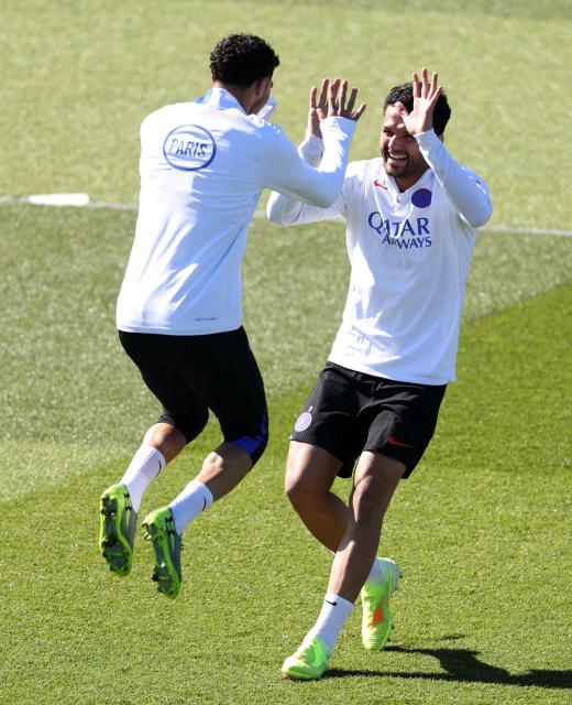 Paris Saint-Germain's Moroccan defender #02 Achraf Hakimi (L) shakes hands with Paris Saint-Germain's Portuguese forward #9 Goncalo Ramos during a training session at the Campus Paris Saint-Germain in Poissy, in the western outskirts of Paris, on April 7, 2026, on the eve of the UEFA Champions League quarter final first leg football match between Paris Saint-Germain and Liverpool F.C. (Photo by FRANCK FIFE / AFP)