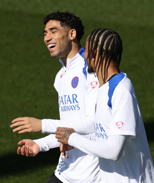 Paris Saint-Germain's Moroccan defender #02 Achraf Hakimi (L) and Paris Saint-Germain's French forward #29 Bradley Barcola laugh before a training session at the Campus Paris Saint-Germain in Poissy, on the western outskirts of Paris on April 7, 2026, on the eve of the UEFA Champions League quarter-final first leg football match against Liverpool F.C. (Photo by FRANCK FIFE / AFP)