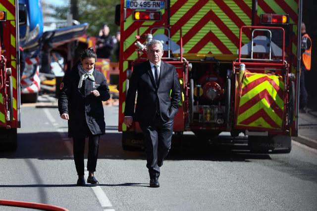 Hauts-de-France region president Xavier Bertrand (R) walks past firefighters vehicles as he arrives after a collision of a TGV train at a level crossing with a lorry between Bethune and Lens, in Bully-les-Mines, in the Pas-de-Calais region, northern France on April 7, 2026. The driver of the TGV train died and 27 people were injured in the accident, AFP has learnt from the prefecture and the SNCF. (Photo by Sameer AL-DOUMY / AFP)