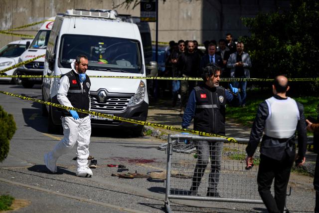 TOPSHOT - Police officials gather outside The Israeli Consulate in Istanbul on April 7, 2026, following a shootout between gunmen and police. One gunman was killed and two others were wounded in a shootout with police outside the Israeli consulate in Istanbul, the local governor said, adding two officers were lightly wounded (Photo by Yasin AKGUL / AFP)