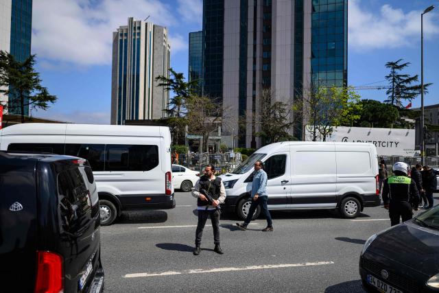 Police officials stand amongst traffic as they patrol near The Israeli Consulate in Istanbul on April 7, 2026, following a shootout between gunmen and police. One gunman was killed and two others were wounded in a shootout with police outside the Israeli consulate in Istanbul, the local governor said, adding two officers were lightly wounded (Photo by Yasin AKGUL / AFP)