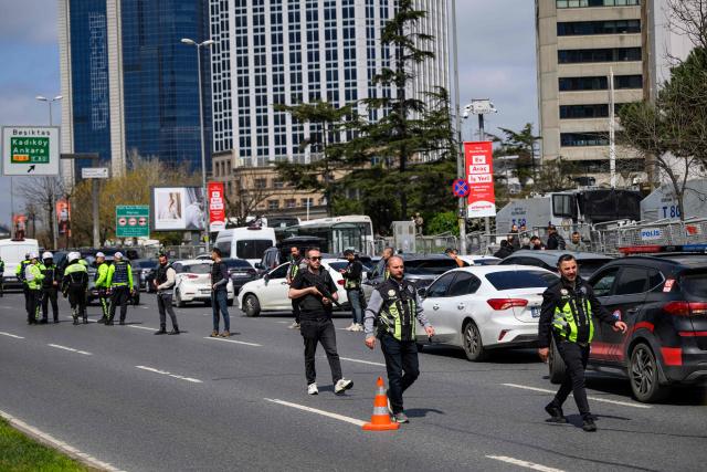 Police officials stand amongst traffic as they patrol near The Israeli Consulate in Istanbul on April 7, 2026, following a shootout between gunmen and police. One gunman was killed and two others were wounded in a shootout with police outside the Israeli consulate in Istanbul, the local governor said, adding two officers were lightly wounded (Photo by Yasin AKGUL / AFP)