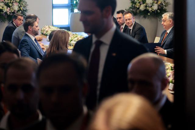 Reporters leave the room as US Vice President JD Vance (3rdL), Hungarian Prime Minister Viktor Orban (R) and Hungarian Foreign Minister Peter Szijjarto (2ndR) attend a meeting in Budapest, Hungary, on April 7, 2026. (Photo by Jonathan Ernst / POOL / AFP)