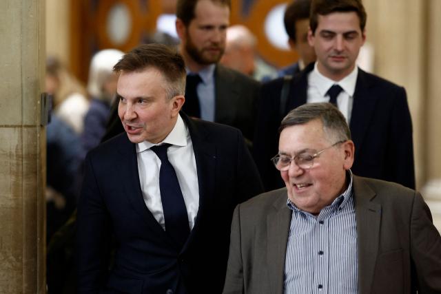 Lawyer of France's former president Nicolas Sarkozy, Christophe Ingrain (L), leaves the courtroom following a recess in former France's president appeal trial over charges he sought Libyan financing for his 2007 election, at the Palais de Justice courthouse in Paris on April 7, 2026. The Paris Criminal Court in September 2025 convicted Sarkozy of criminal conspiracy and handed him a 5-year prison sentence over what it said was a scheme to acquire funding from Muammar Gaddafi's Libya for his 2007 presidential run that saw him elected. The right-wing politician -- who has denied any wrongdoing -- entered a Paris jail in October 2025, serving 20 days before he was released under judicial supervision. (Photo by Kenzo TRIBOUILLARD / AFP)
