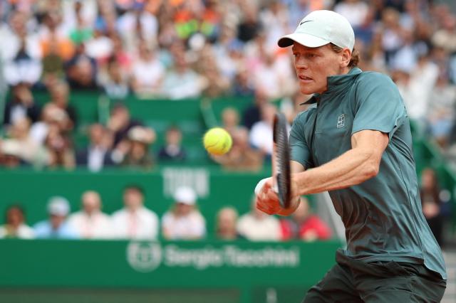 Italy's Jannik Sinner plays a backhand return to France's Ugo Humbert during the Monte Carlo ATP Masters Series Tournament round of 64 tennis match on Court Rainier III at the Monte-Carlo Country Club in Roquebrune-Cap-Martin, south-eastern France on April 7, 2026. (Photo by Valery HACHE / AFP)