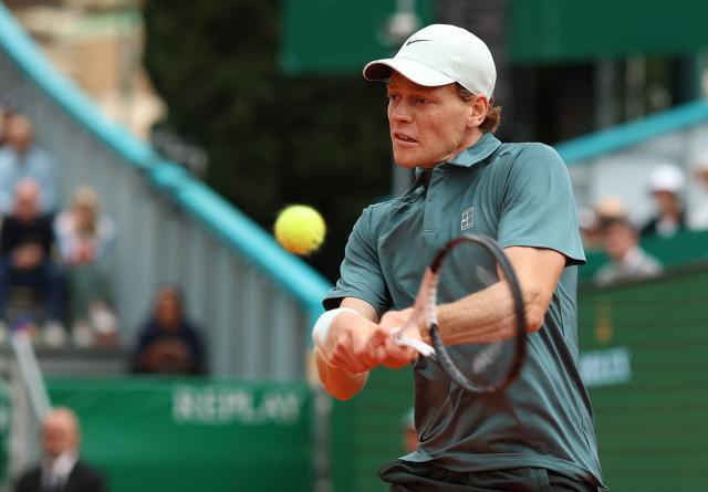 Italy's Jannik Sinner plays a backhand return to France's Ugo Humbert during the Monte Carlo ATP Masters Series Tournament round of 64 tennis match on Court Rainier III at the Monte-Carlo Country Club in Roquebrune-Cap-Martin, south-eastern France on April 7, 2026. (Photo by Valery HACHE / AFP)