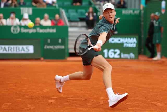 Italy's Jannik Sinner plays a backhand return to France's Ugo Humbert during the Monte Carlo ATP Masters Series Tournament round of 64 tennis match on Court Rainier III at the Monte-Carlo Country Club in Roquebrune-Cap-Martin, south-eastern France on April 7, 2026. (Photo by Valery HACHE / AFP)