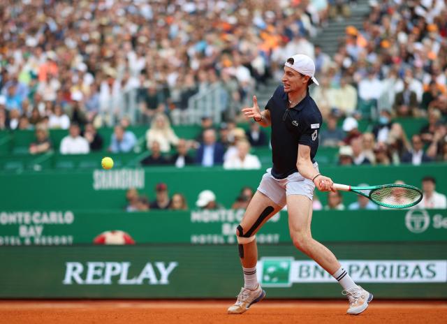 France's Ugo Humbert plays a forehand return to Italy's Jannik Sinner during the Monte Carlo ATP Masters Series Tournament round of 64 tennis match on Court Rainier III at the Monte-Carlo Country Club in Roquebrune-Cap-Martin, south-eastern France on April 7, 2026. (Photo by Valery HACHE / AFP)