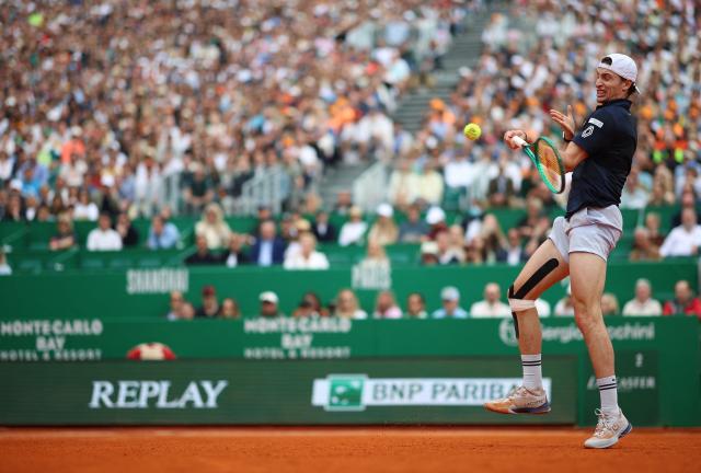 France's Ugo Humbert plays a forehand return to Italy's Jannik Sinner during the Monte Carlo ATP Masters Series Tournament round of 64 tennis match on Court Rainier III at the Monte-Carlo Country Club in Roquebrune-Cap-Martin, south-eastern France on April 7, 2026. (Photo by Valery HACHE / AFP)