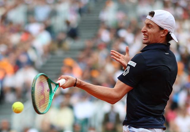 France's Ugo Humbert plays a forehand return to Italy's Jannik Sinner during the Monte Carlo ATP Masters Series Tournament round of 64 tennis match on Court Rainier III at the Monte-Carlo Country Club in Roquebrune-Cap-Martin, south-eastern France on April 7, 2026. (Photo by Valery HACHE / AFP)