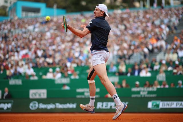 France's Ugo Humbert plays a forehand return to Italy's Jannik Sinner during the Monte Carlo ATP Masters Series Tournament round of 64 tennis match on Court Rainier III at the Monte-Carlo Country Club in Roquebrune-Cap-Martin, south-eastern France on April 7, 2026. (Photo by Valery HACHE / AFP)