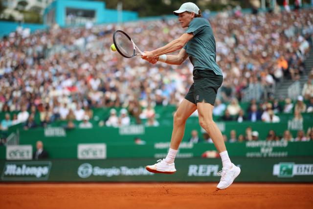 Italy's Jannik Sinner plays a backhand return to France's Ugo Humbert during the Monte Carlo ATP Masters Series Tournament round of 64 tennis match on Court Rainier III at the Monte-Carlo Country Club in Roquebrune-Cap-Martin, south-eastern France on April 7, 2026. (Photo by Valery HACHE / AFP)