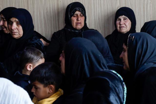 Mourners gather during a condolence ceremony for members of an Iraqi Kurdish family who were killed after a drone crashed into a house in the village of Zargazawi, north of Erbil in Iraq's northern autonomous Kurdistan region, on April 7, 2026. Local authorities reported a deadly drone incident in a civilian area in the early hours of April 7. The autonomous region's Counter-Terrorism Service said a "bomb-laden drone coming from Iran" crashed into a home in the Dara Shakran subdistrict of Erbil province after midnight, killing a couple. Since the Middle East war erupted on February 28, shadowy Iraq-based groups have been claiming near daily attacks on US interests in the country and beyond. (Photo by Safin HAMID / AFP)
