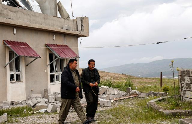 Kurdish men inspect the damage after a drone crashed into a house in the village of Zargazawi, north of Erbil in Iraq's northern autonomous Kurdistan region, on April 7, 2026. Local authorities reported a deadly drone incident in a civilian area in the early hours of April 7. The autonomous region's Counter-Terrorism Service said a "bomb-laden drone coming from Iran" crashed into a home in the Dara Shakran subdistrict of Erbil province after midnight, killing a couple. Since the Middle East war erupted on February 28, shadowy Iraq-based groups have been claiming near daily attacks on US interests in the country and beyond. (Photo by Safin HAMID / AFP)