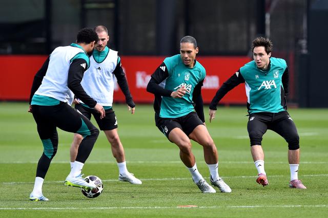 Liverpool's Dutch defender #04 Virgil van Dijk (C) and Liverpool's Italian striker #14 Federico Chiesa (R) attend a team training session at their training ground in Kirkby, Liverpool, north-west England on April 7, 2026, on the eve of their UEFA Champions League, quarter final first leg football match against Paris Saint-Germain. (Photo by PETER POWELL / AFP)